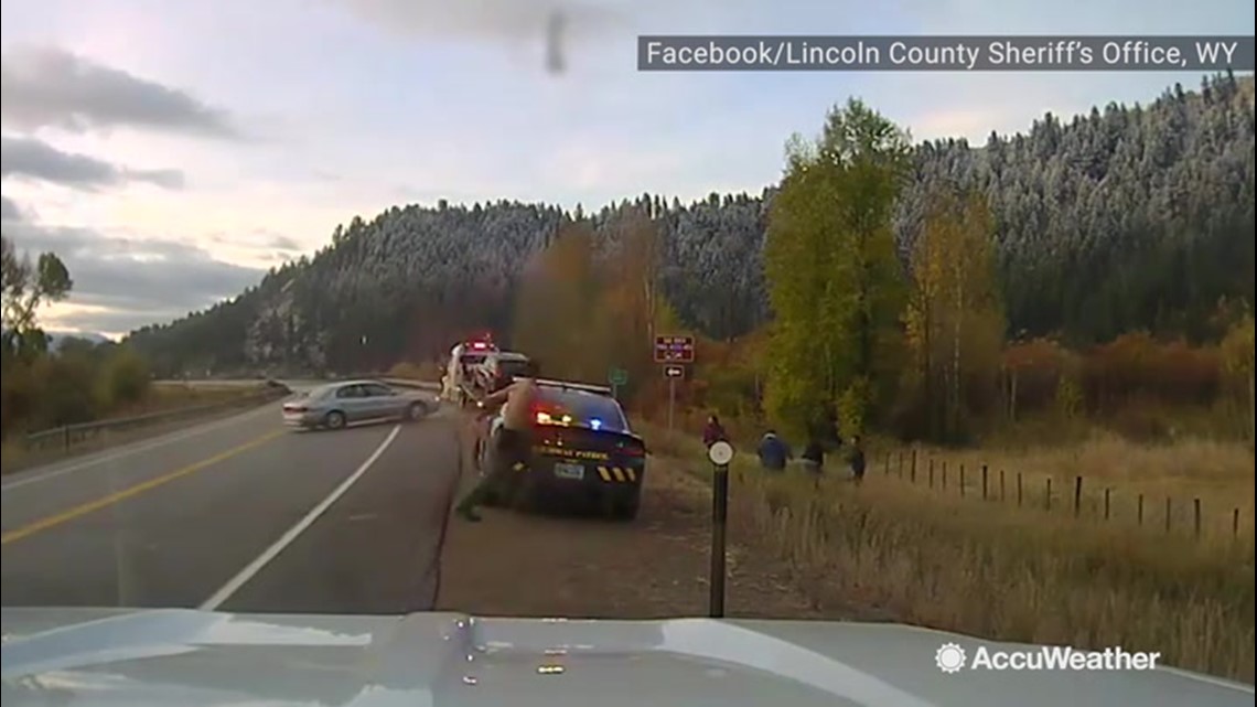 Black ice causes car to skid out of control, nearly striking police car ...