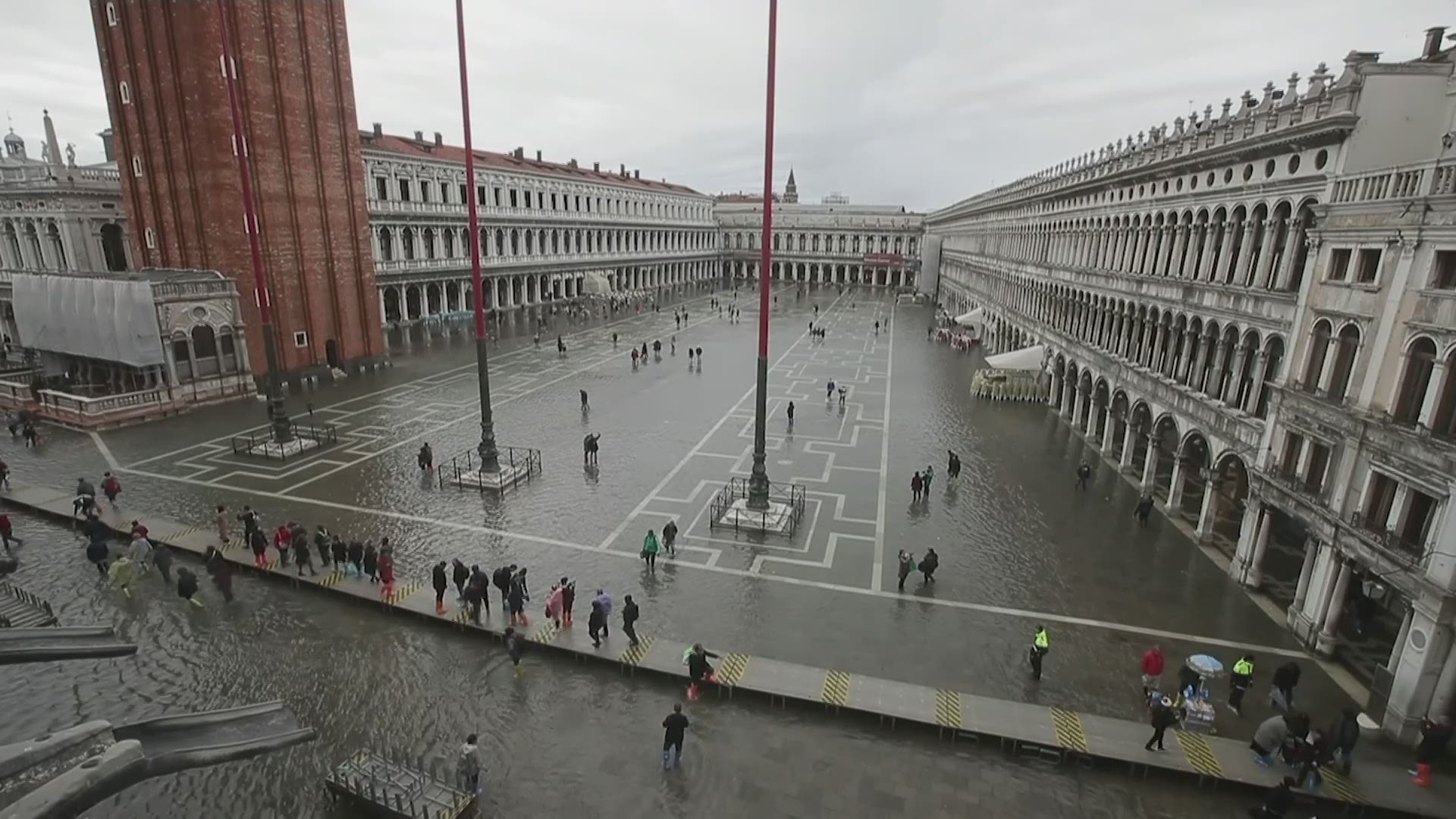 Tourists and Venetians alike have donned high boots and taken to raised walkways to slosh through the high water. (AP)