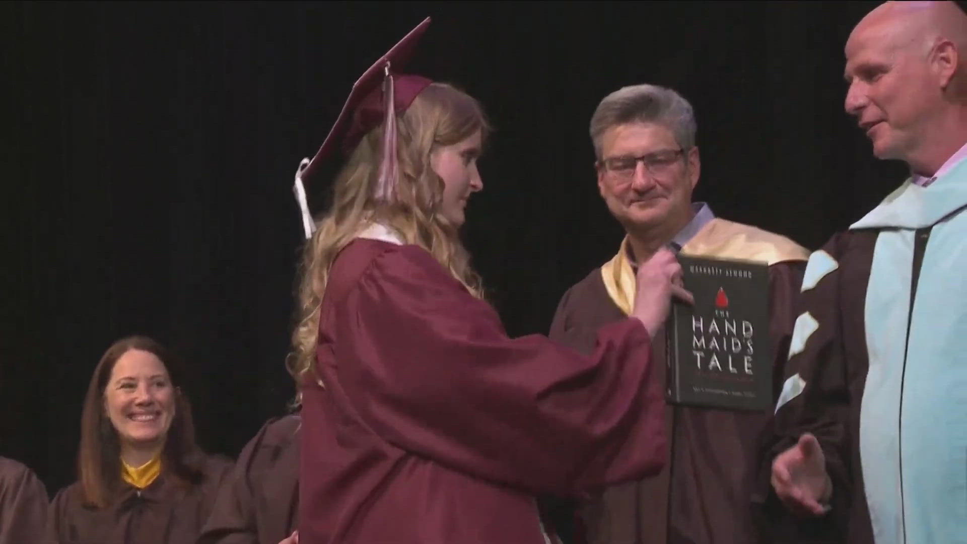 2024 grad Annabelle Jenkins tried to give the superintendent a banned book called "The Hand Maid's Tale." After he didn't take it, she left it at his feet and left.