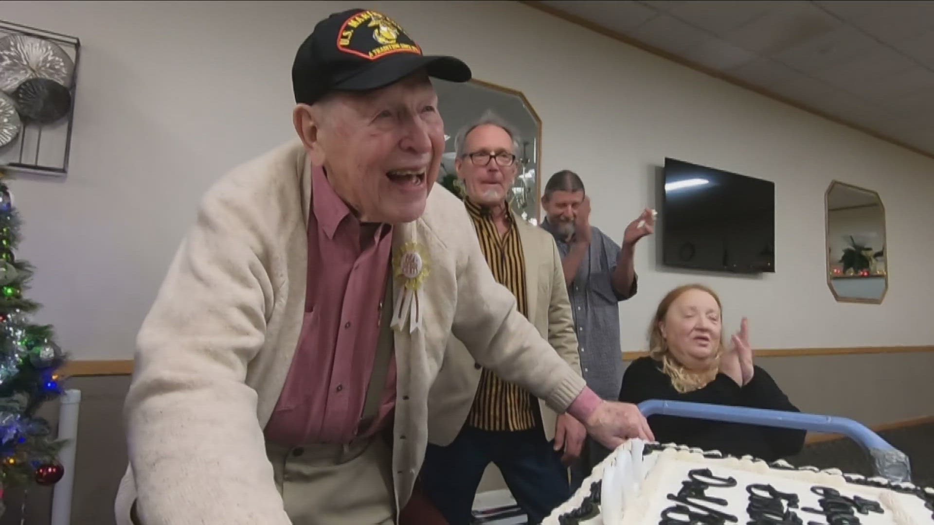 Overwhelmed by happiness as he celebrates his 100th birthday with friends and family.