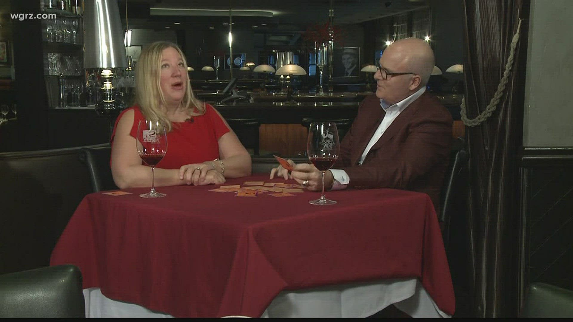 Kevin enjoys a glass of wine and plays a flash card game with Donna Schlosser-Long.