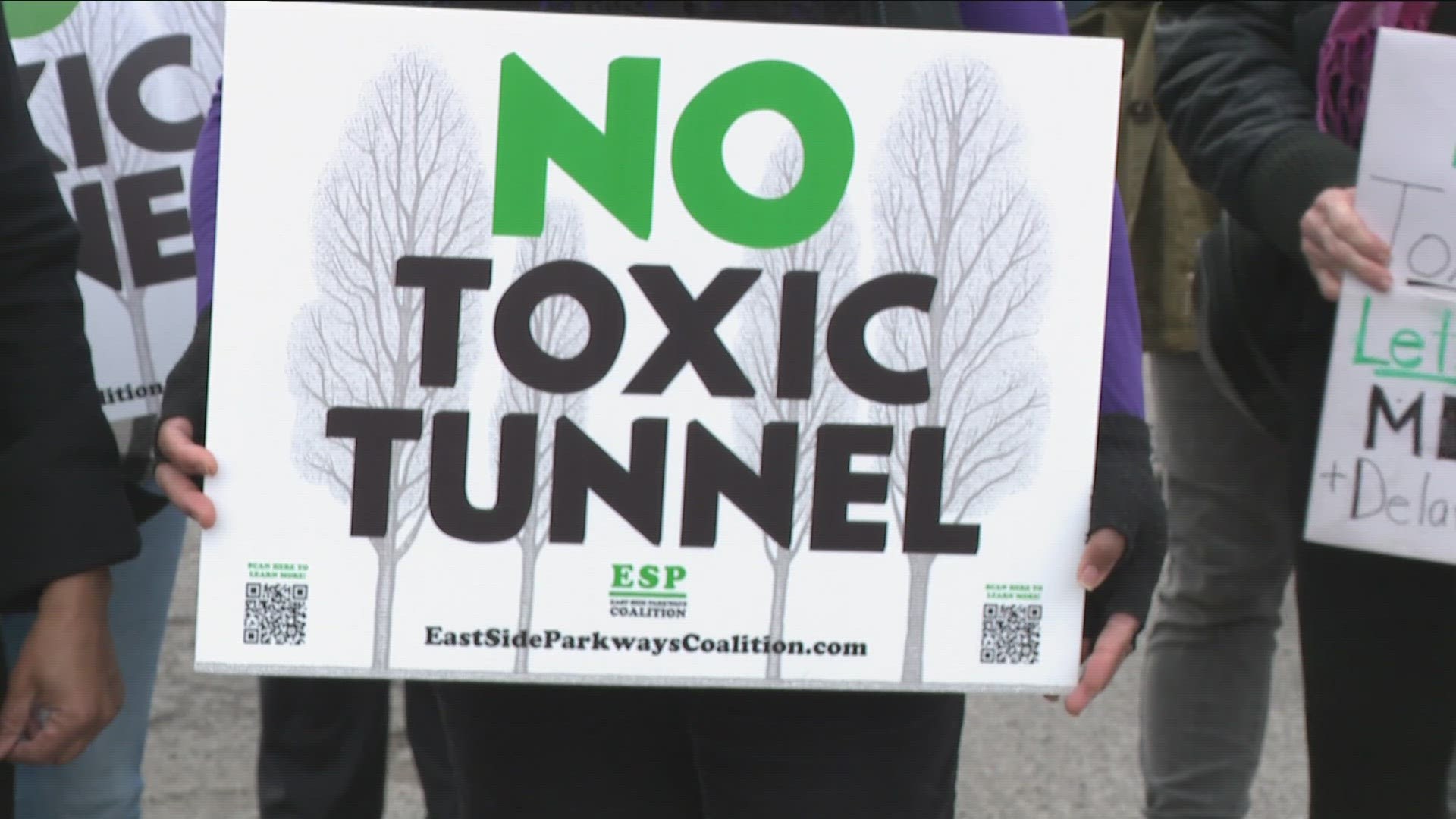 Demonstrators with signs reading 'no toxic tunnel' gathered along East Ferry, protesting the state's plan to convert a below-grade section of the 33 into a tunnel.