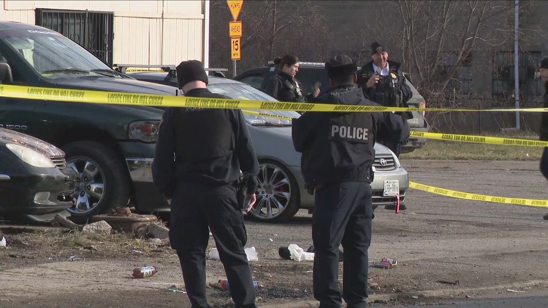 Multiple Buffalo police vehicles and yellow police tape are blocking off a section of the road.