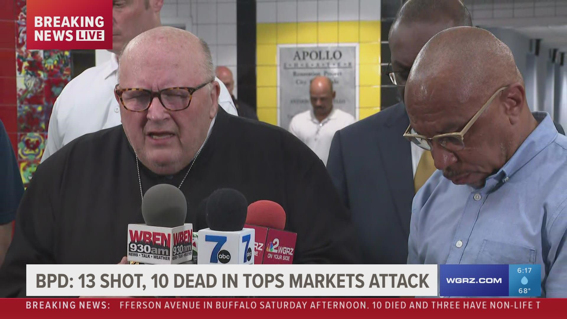 Leaders pray after a press conference about a mass shooting that killed 10 people at a supermarket in Buffalo, NY.