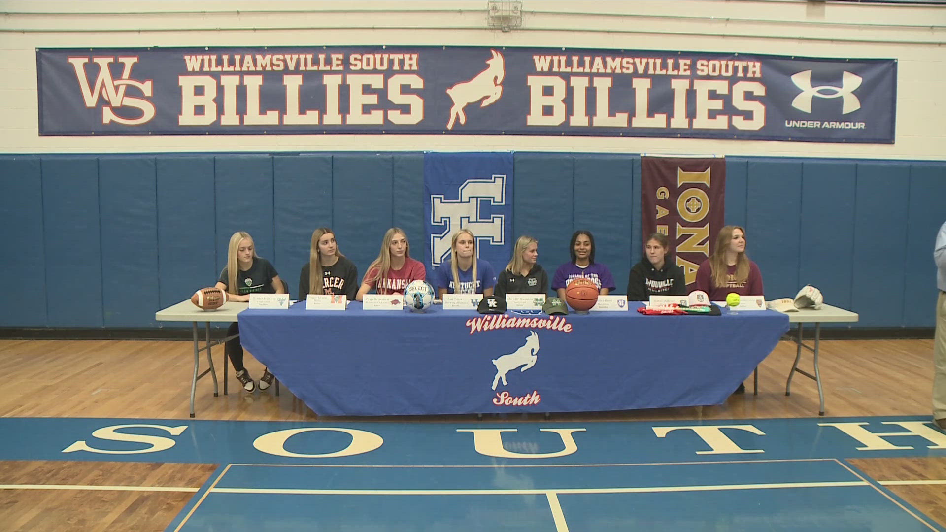 Eight girls signing letters of intent