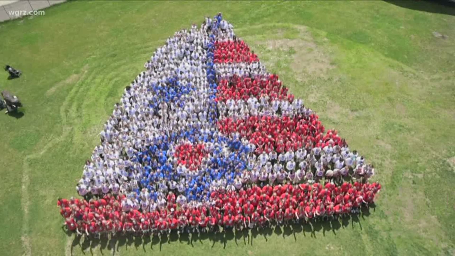 Hundreds of people stood to form the shape of something representing the Queen City.