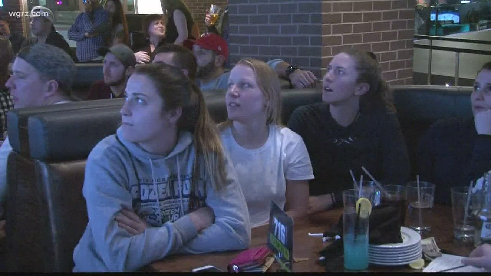 Members of Buffalo Beauts cheer on Emily Pfalzer and Team USA