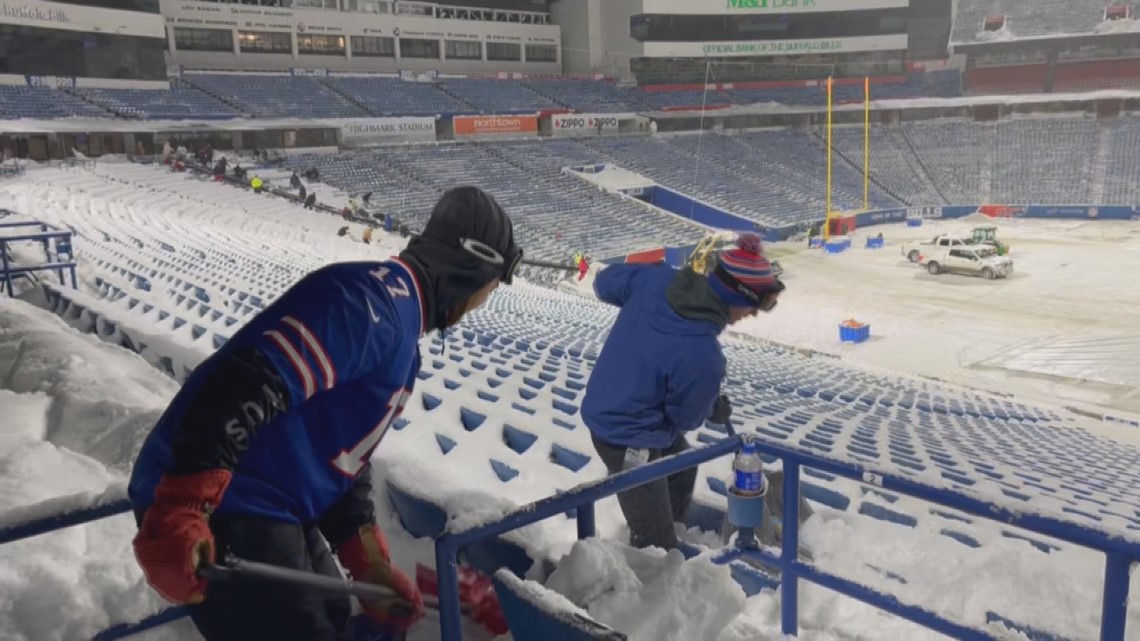 Buffalo Bills fans work hard and play hard while shovelling snow at stadium
