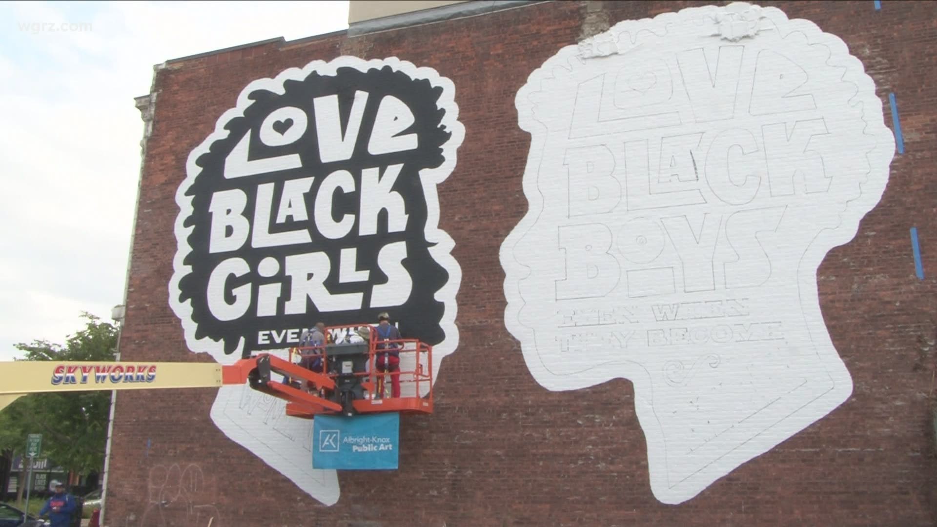 Its features two silhouetted profiles with the messages "Love black boys when they become men and love black girls when they become women."