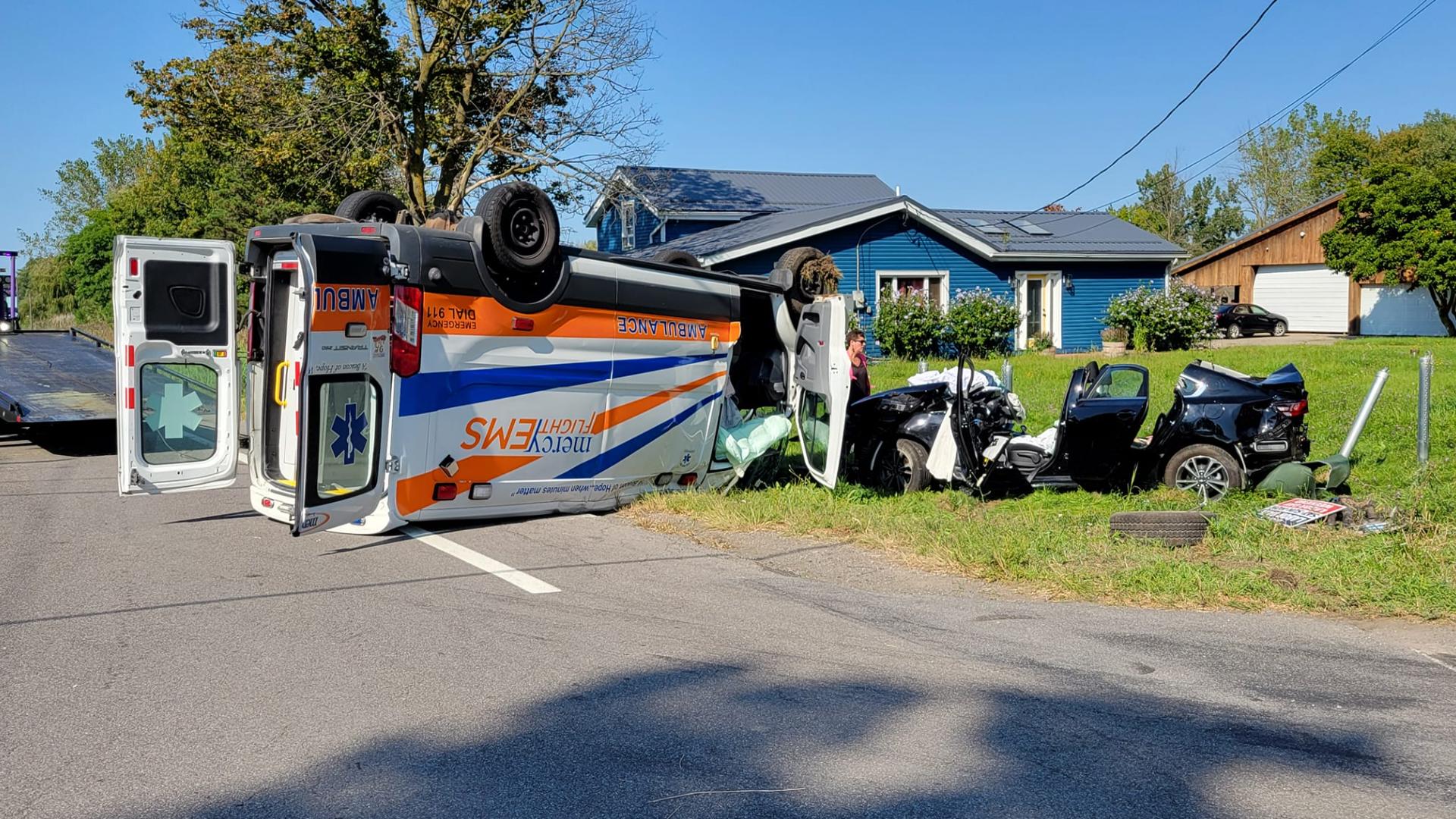 Ambulance carrying a patient, crew rolls over after it was struck by ...