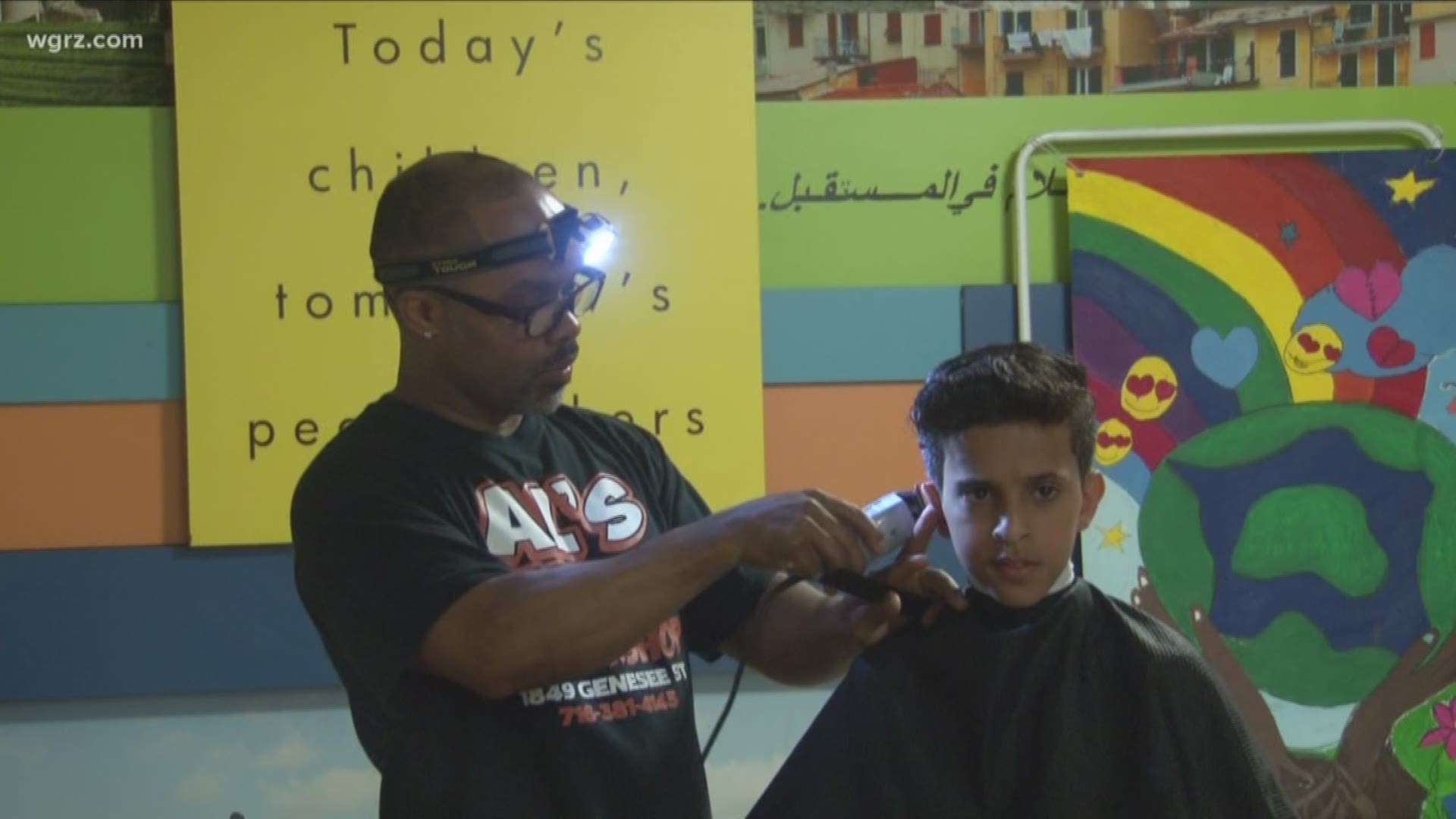 where his students train by giving free haircuts to kids at the international school in Buffalo.