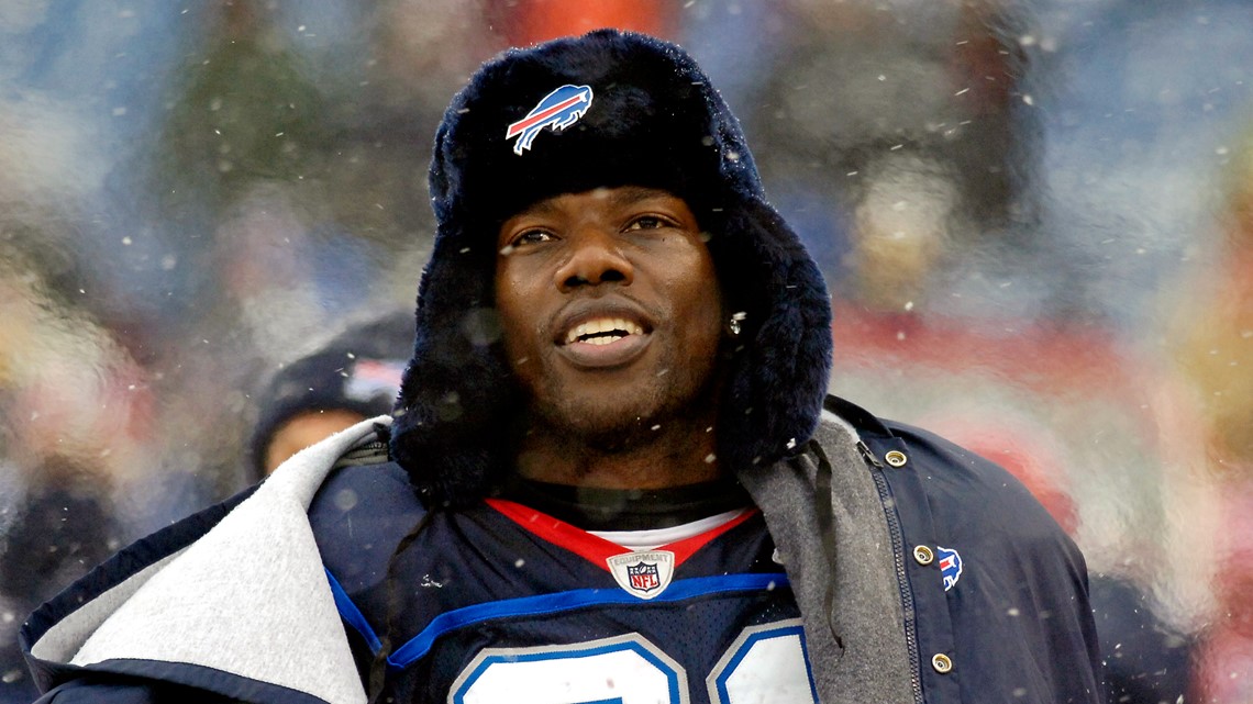 Buffalo Bills' Terrell Owens celebrates his touchdown on the replay screen  as a worker clears snow off the field during the NFL football game against  the Indianapolis Colts in Orchard Park, N.Y.