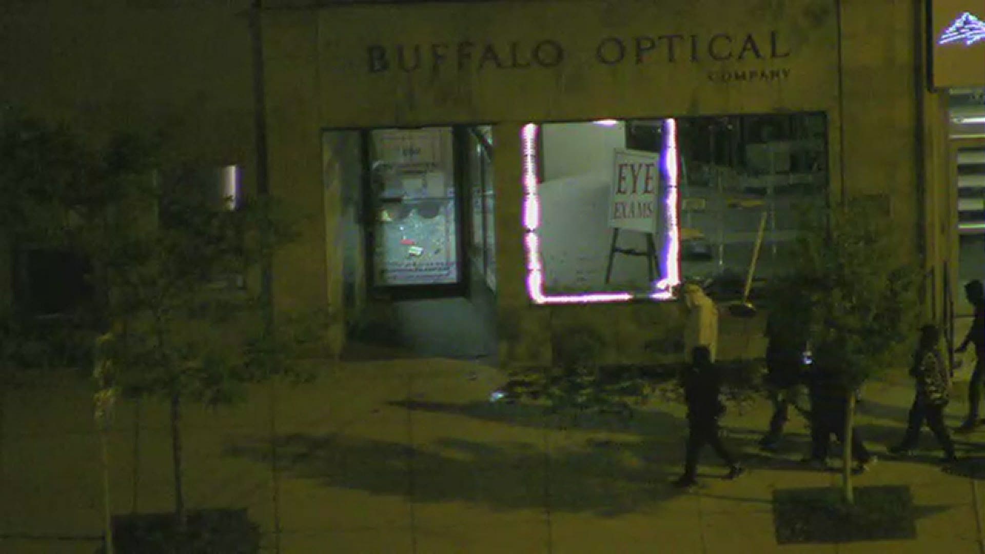 Buffalo Optical was vandalized during protest. While most people walked by the damaged building, at least one person was seen inside the building