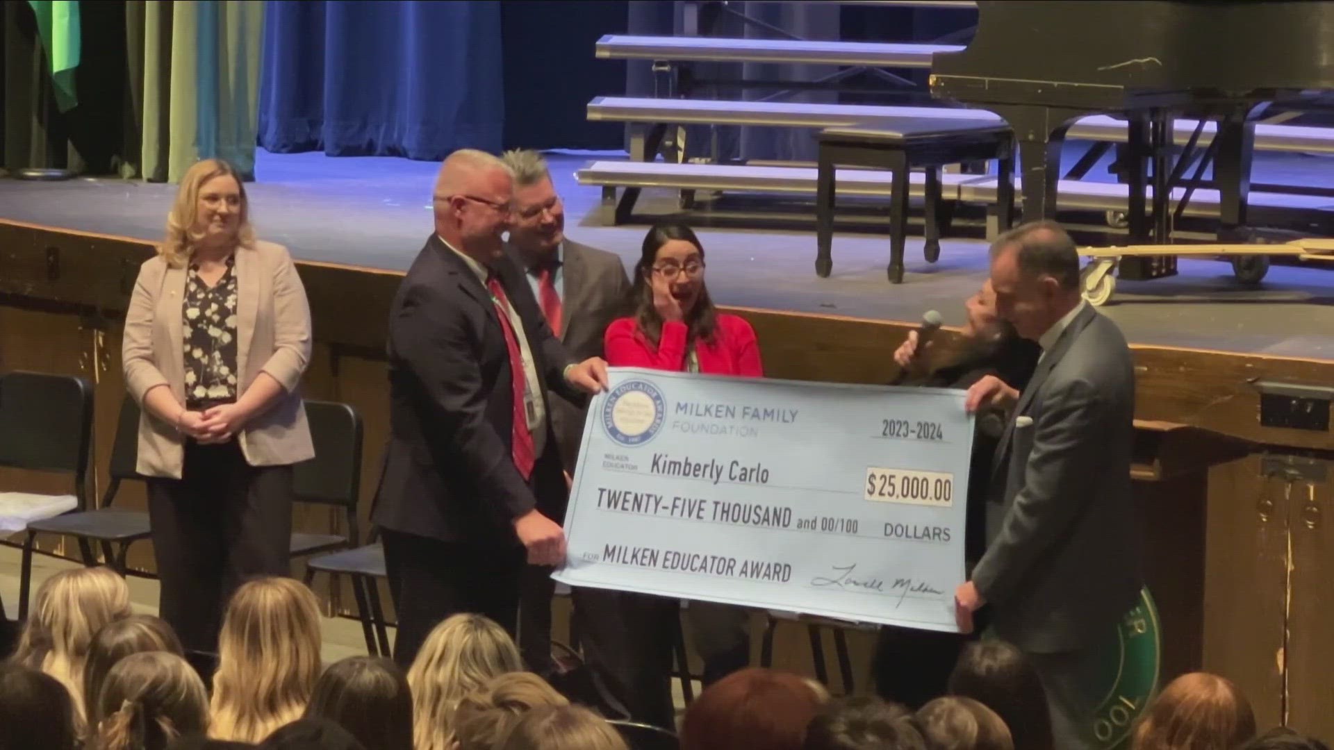 Kimberly Alexander Carlo was surprised at an assembly with the $25,000 award.