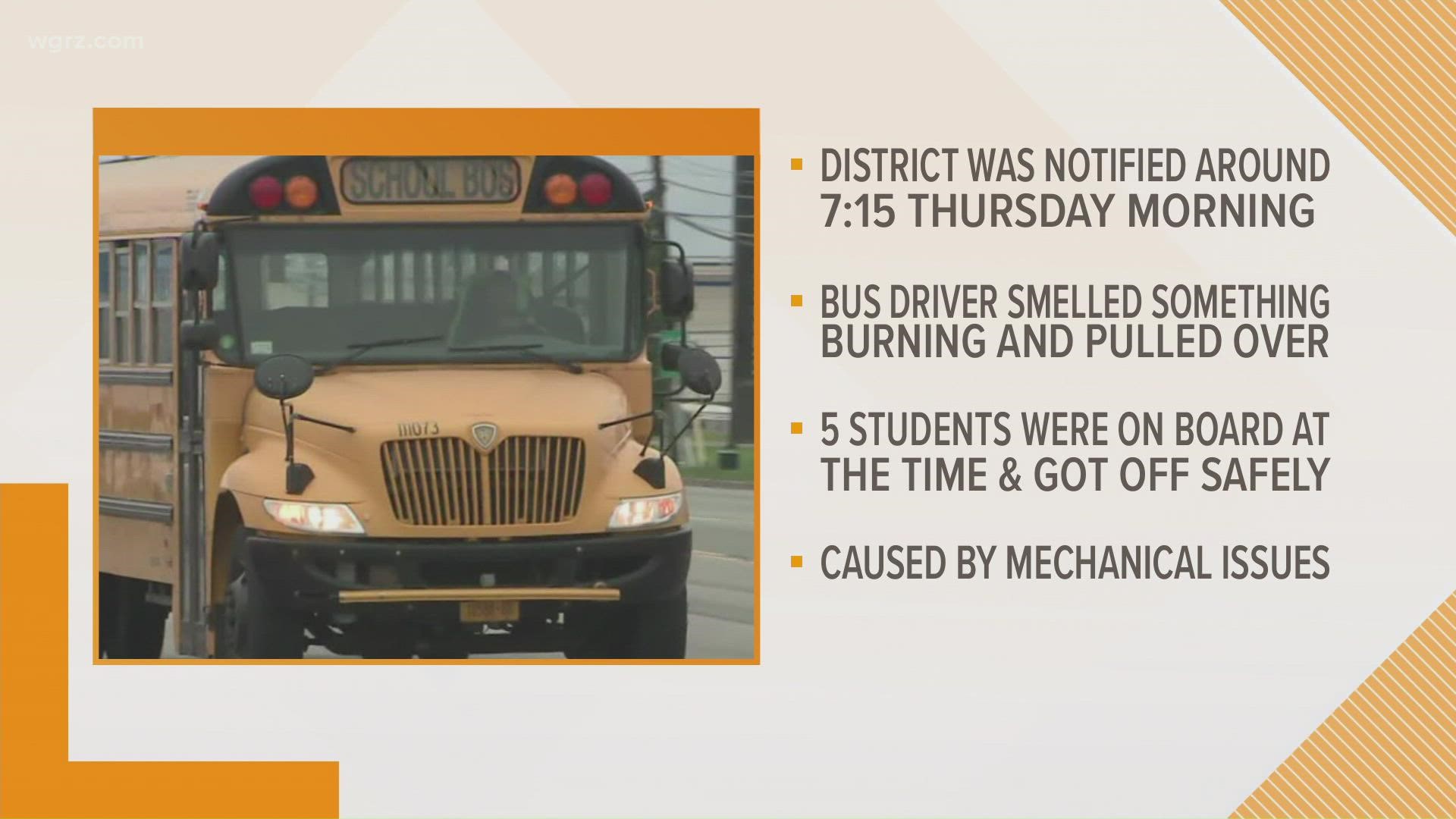 the bus driver smelled something burning, pulled over, got the students off the bus and called 9-1-1.