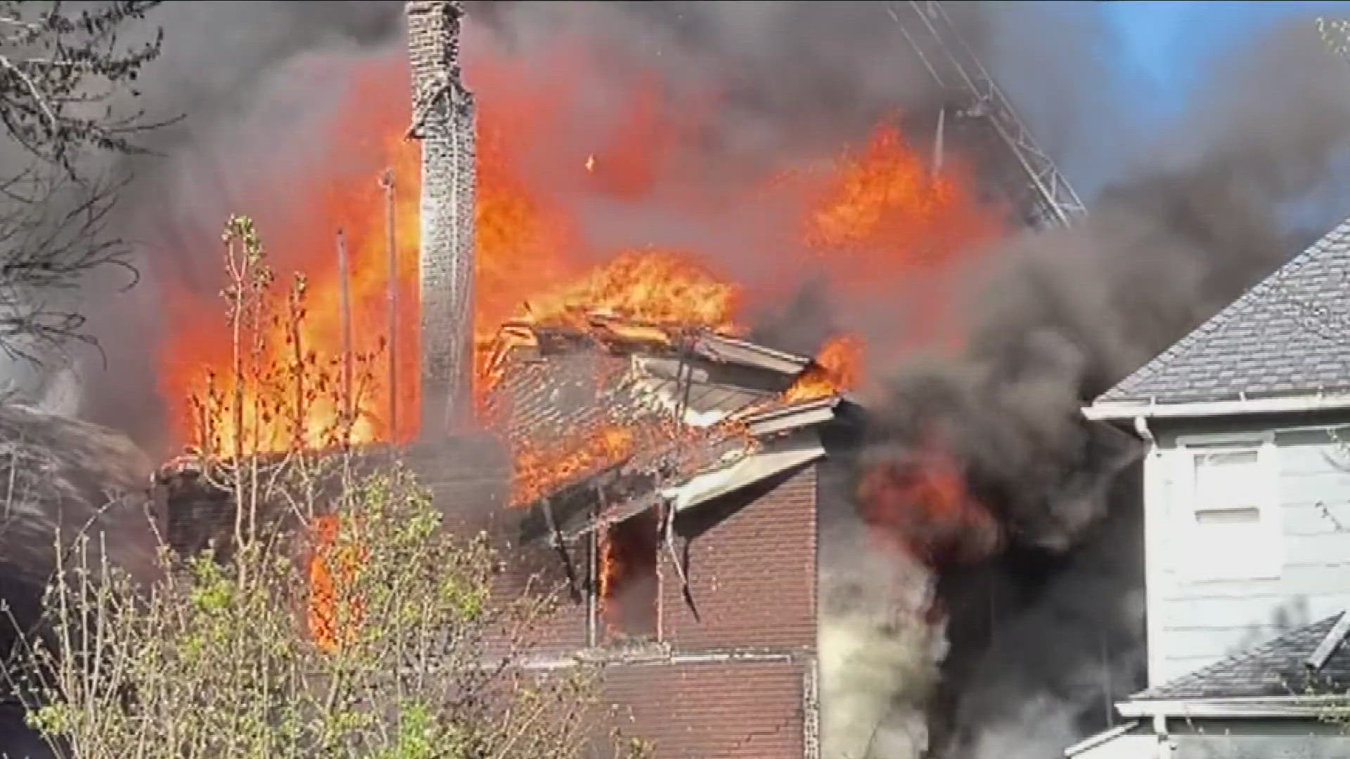 Firefighters battled intense flames and neighboring houses were damaged.