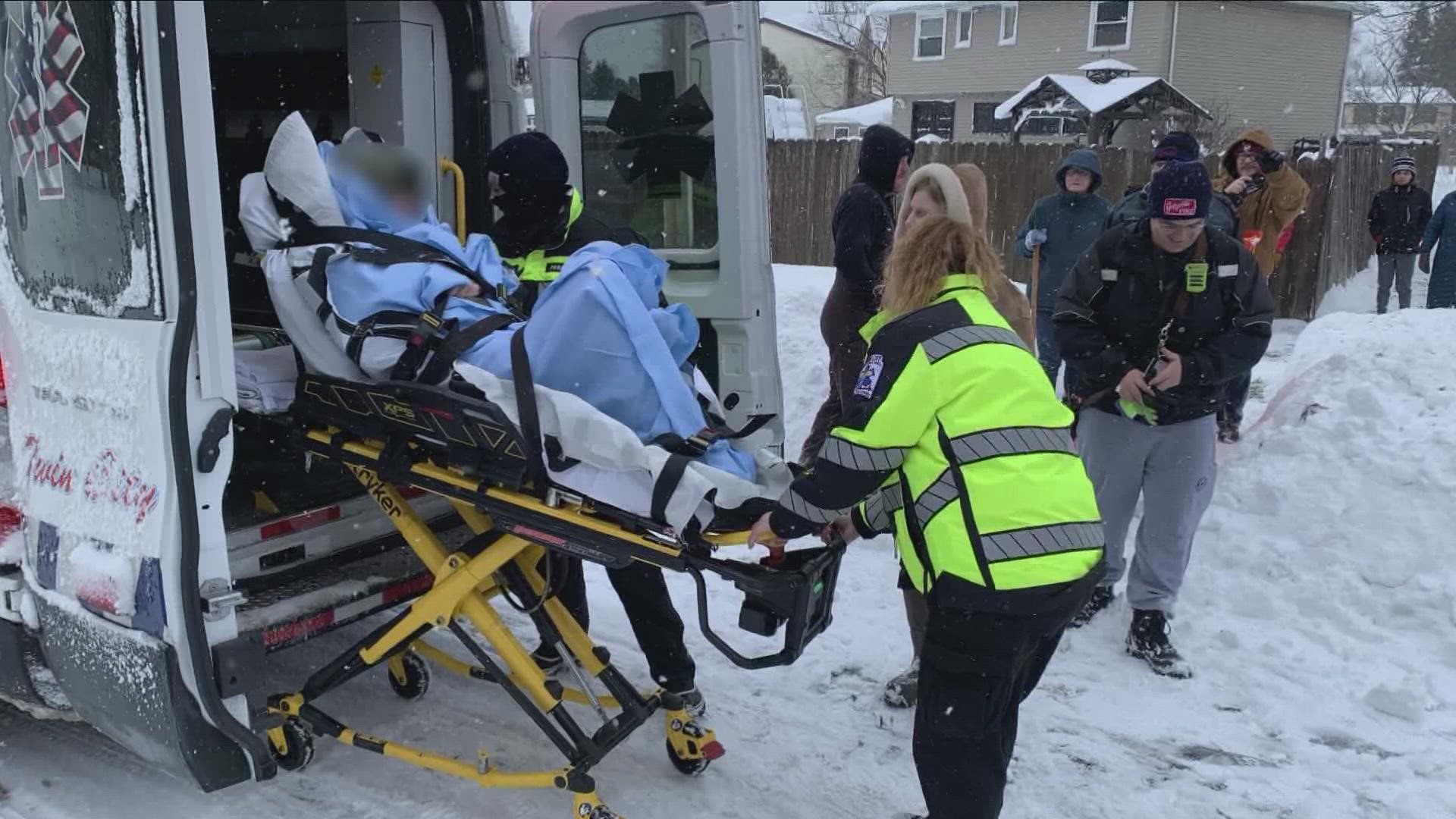 Dozens of neighbors cleared a path in the snow to help get a neighbor, suffering a medical emergency, to a waiting ambulance.