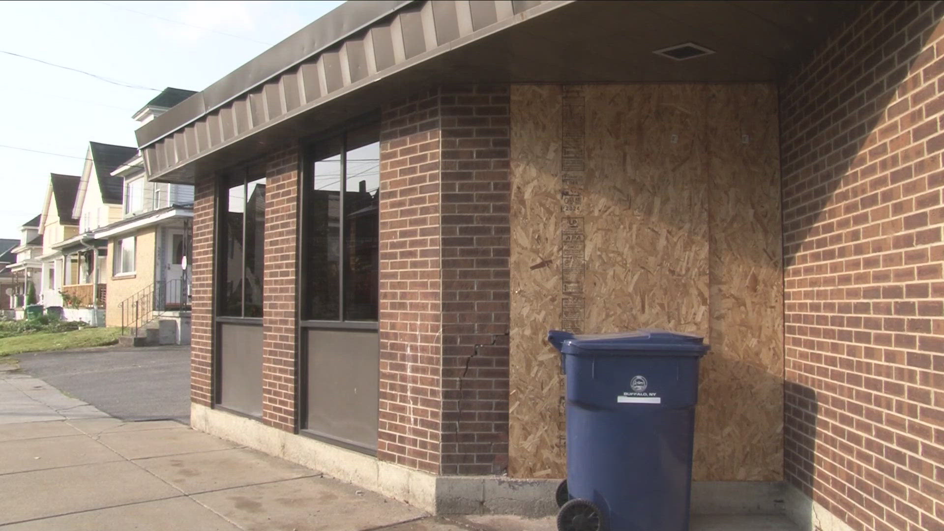 A small part of the building is boarded up and cracked after the crash.