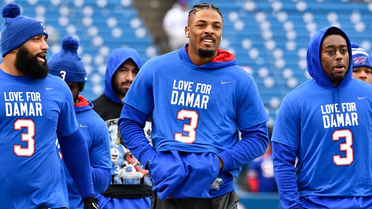 Buffalo Bills quarterback Josh Allen, center, walks the field during  practice while players wear the number 3 in support of safety Damar Hamlin  during practice before an NFL football game against the