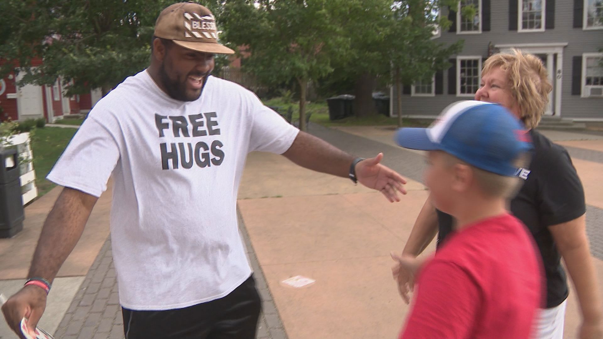 Trey Young has become well known across town for standing on the side of the street, offering free hugs and a smile.