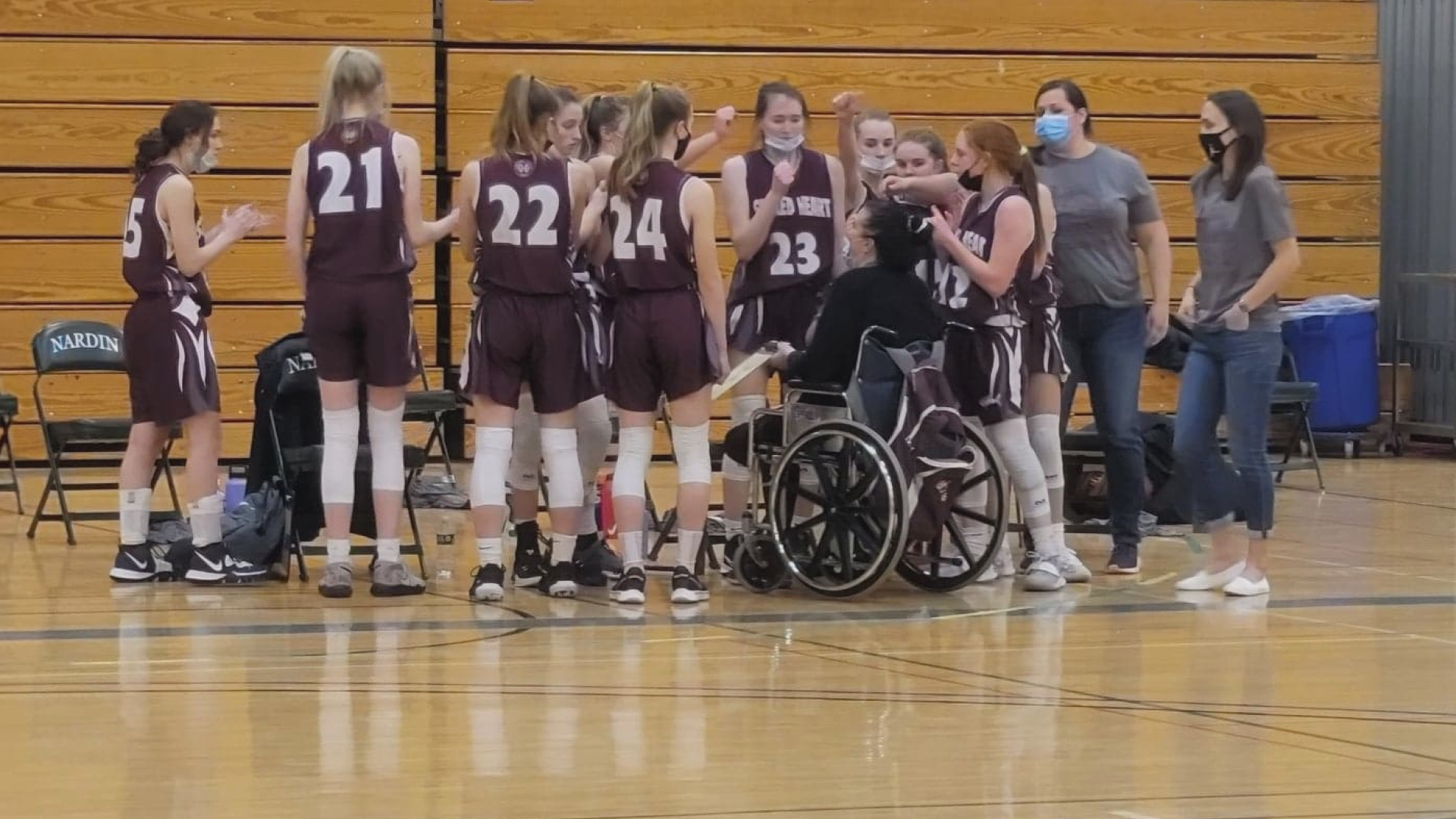 Sacred Heart Academy's varsity basketball coach returned to court for the very first time since an accident that nearly claimed her life four months ago.