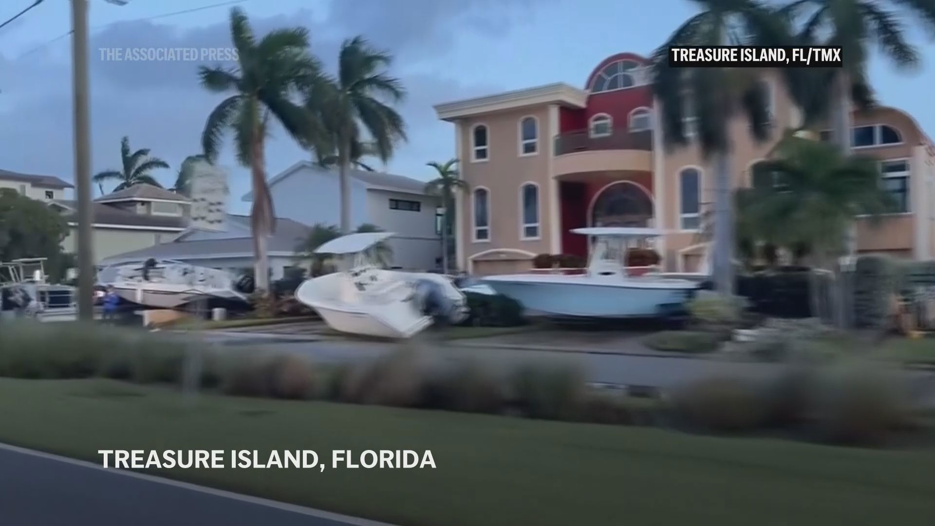 Boats were piled up in driveways and in front yards and neighborhoods were littered with debris and tree limbs (Associated Press)