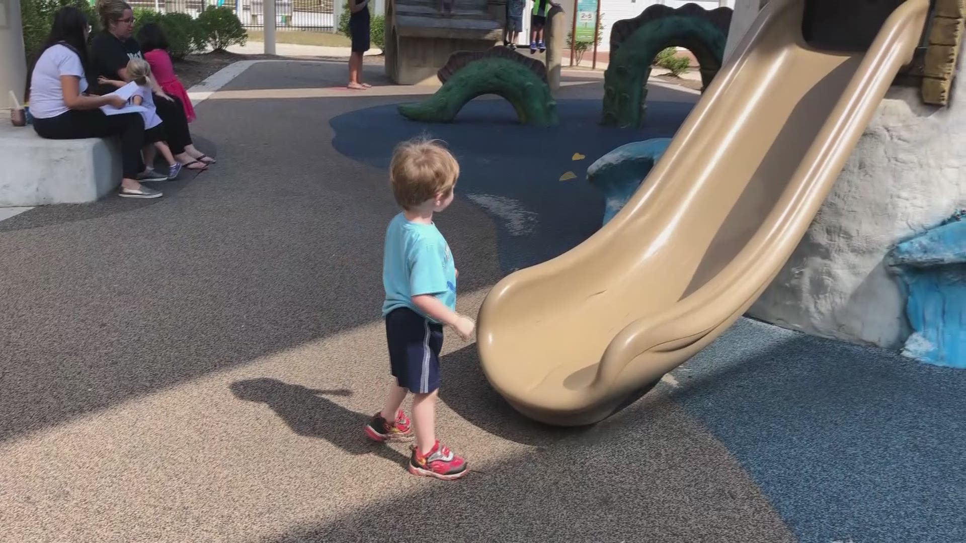 Military kid, Henry Long plays at playground.